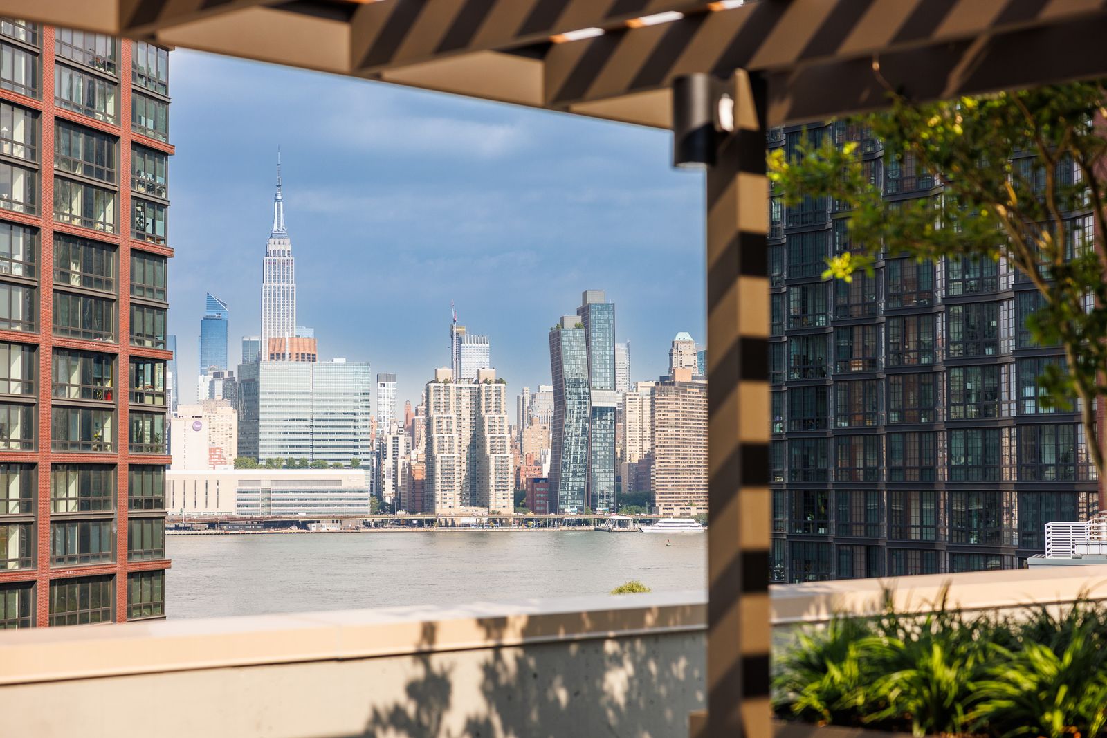 Rooftop terrace with BBQ grills and Brooklyn skyline views at Greenpoint Central