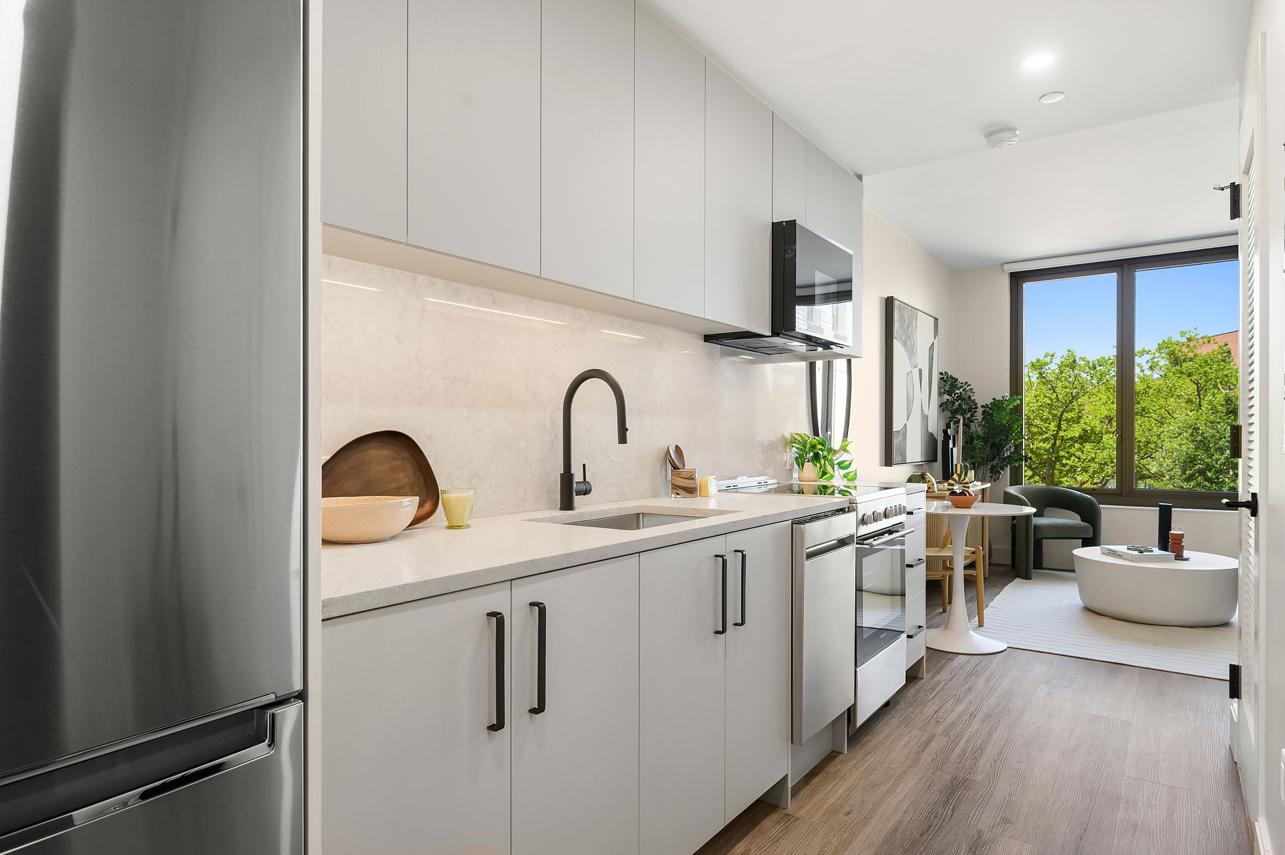 Modern kitchen with quartz countertops and stainless steel appliances Greenpoint apartments